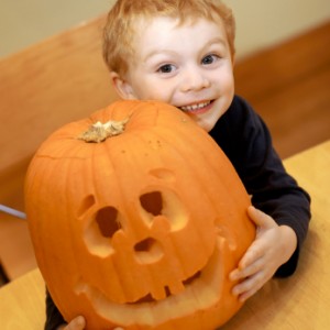 Young boy and jack o' lantern